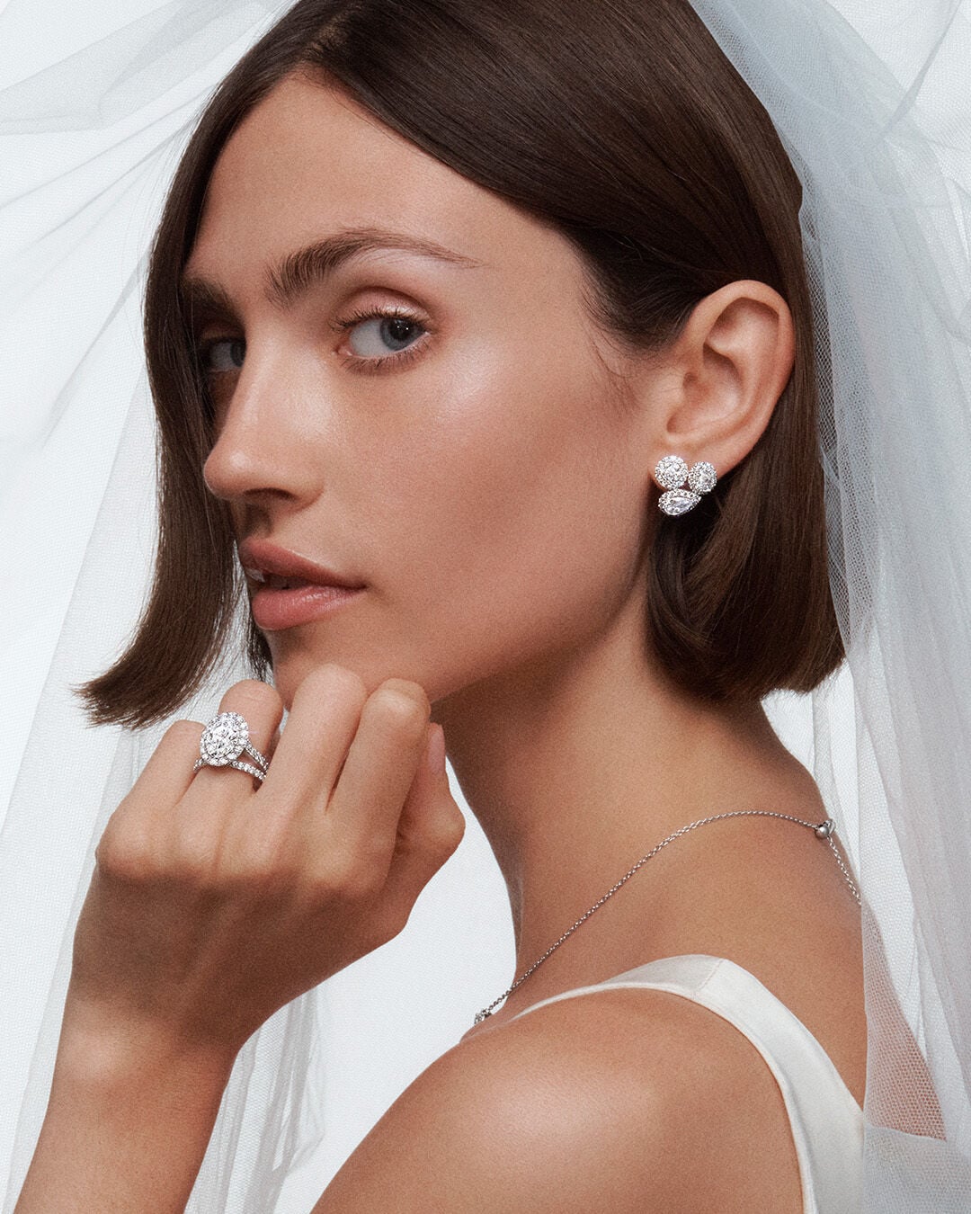 Image of model wearing Graff Icon Engagement ring, diamond wedding band and Icon earrings