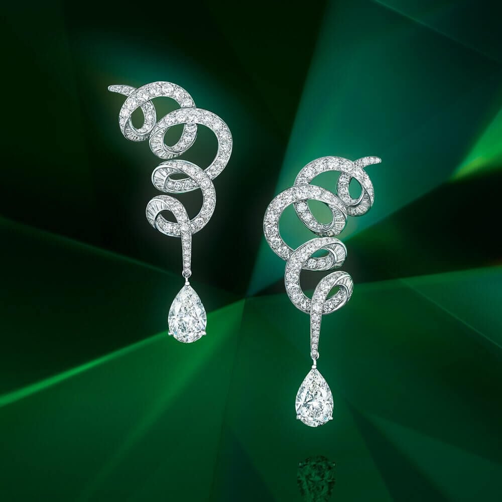 A pair of Graff earrings inspired by Twombly on green background