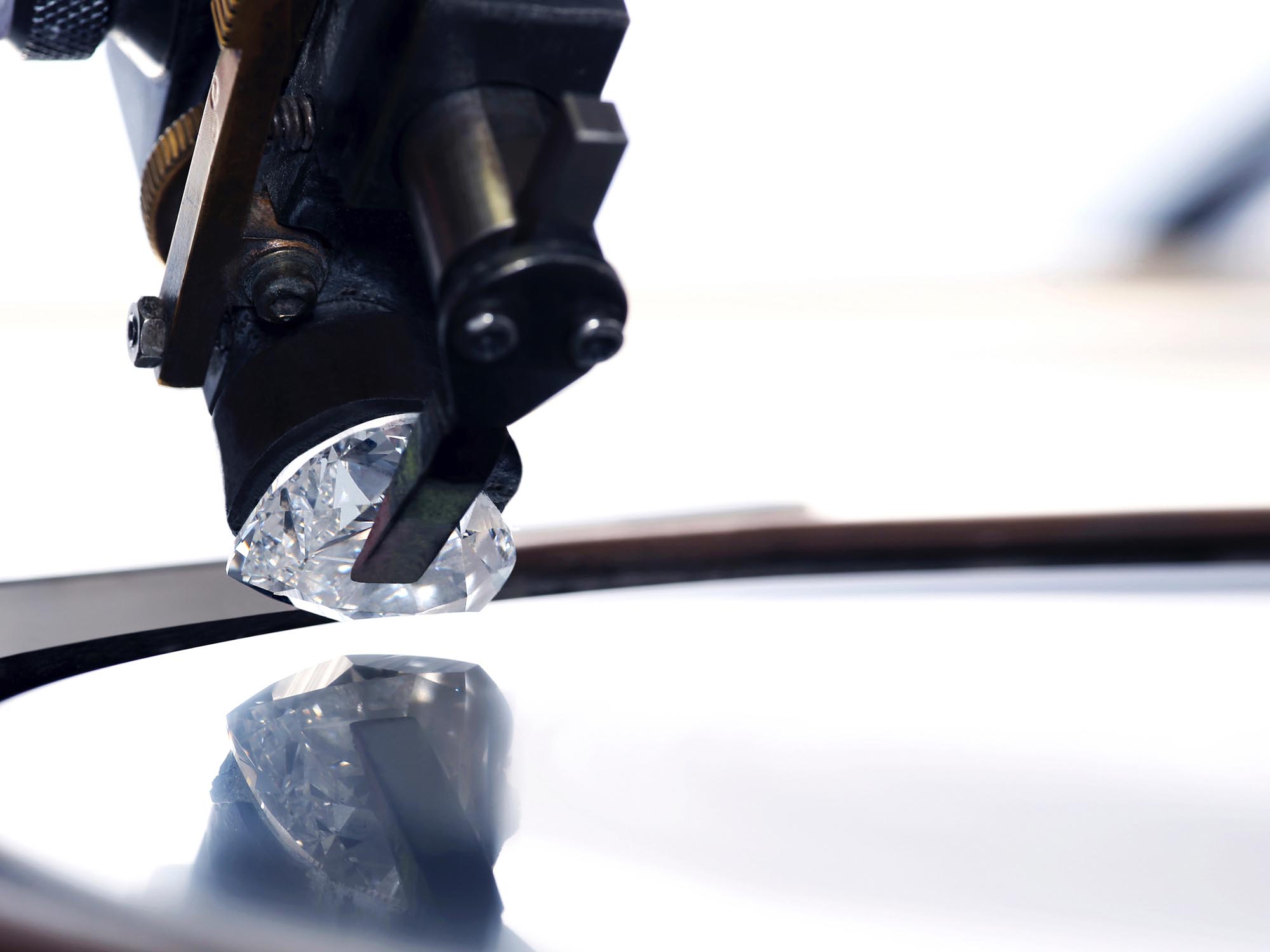 A heart shape diamond on a polishing wheel in the Graff workshop