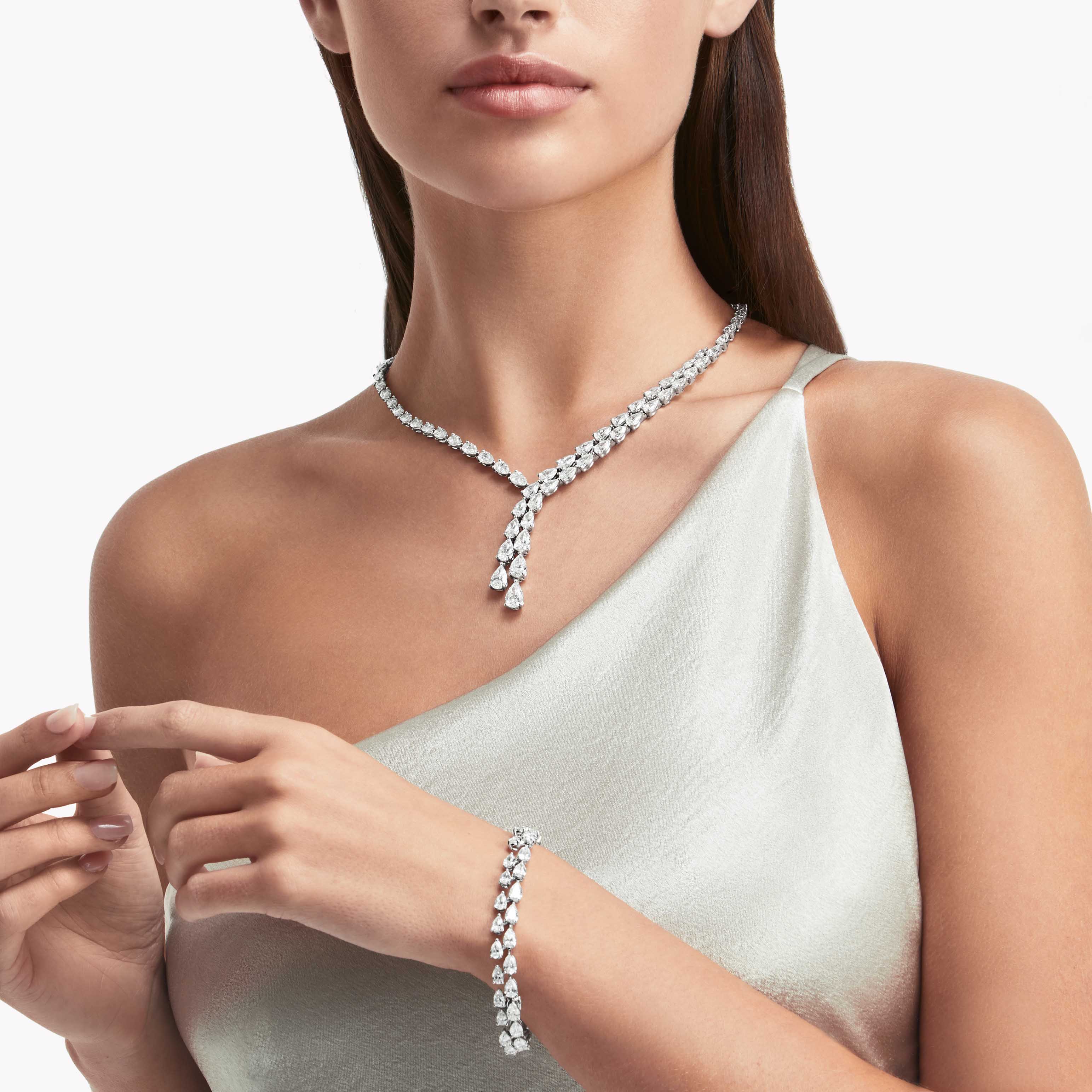 Model wearing Graff Pear Shape Diamond Cross-over Necklace PLATINUM AND WHITE GOLD and Graff Pear Shape Diamond Bracelet WHITE GOLD