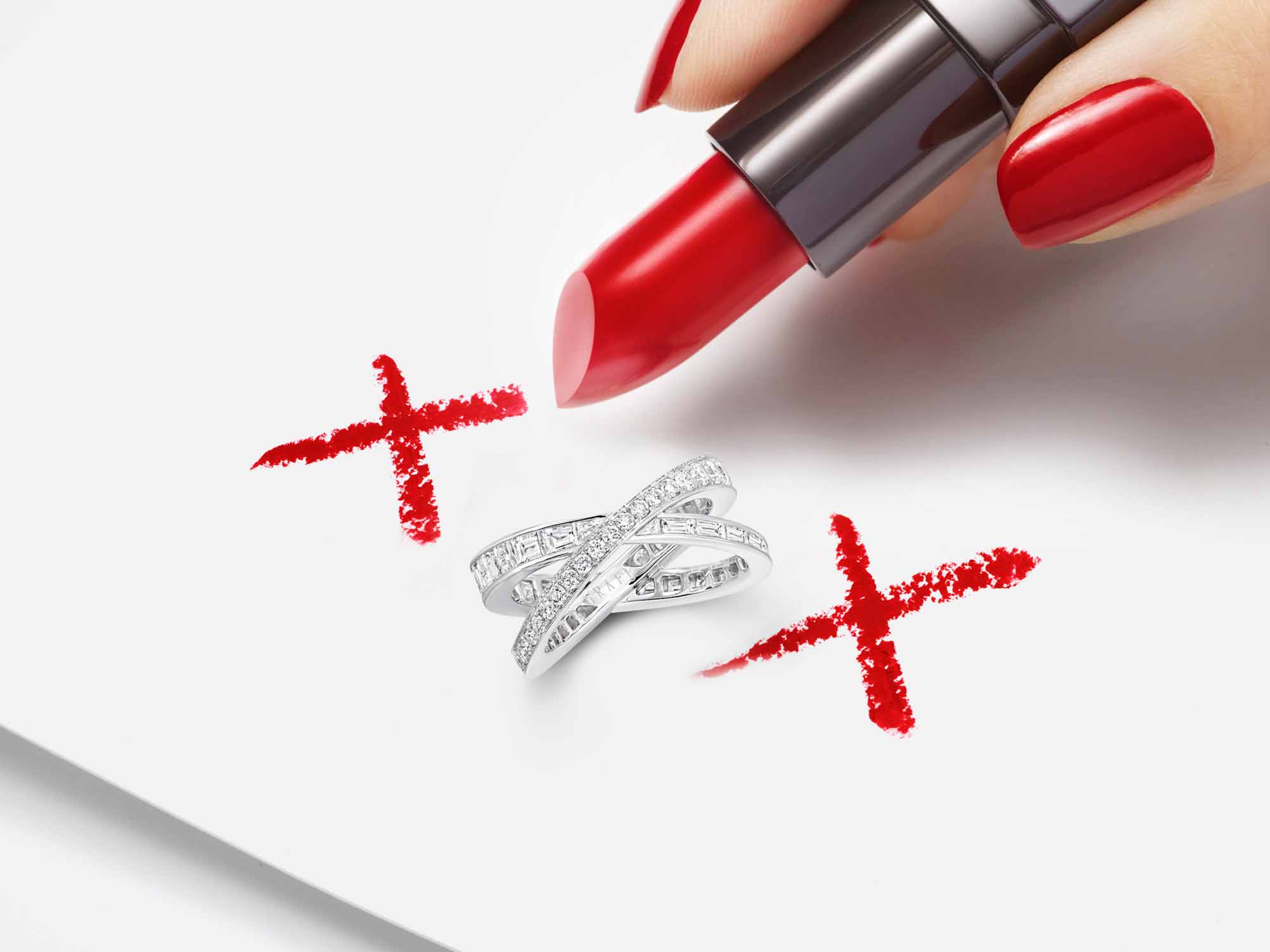 Model drawing kiss symbols with red lipstick and a Kiss Pavé Baguette and round Diamond Ring  from the Graff Spiral Jewellery Collection in the middle